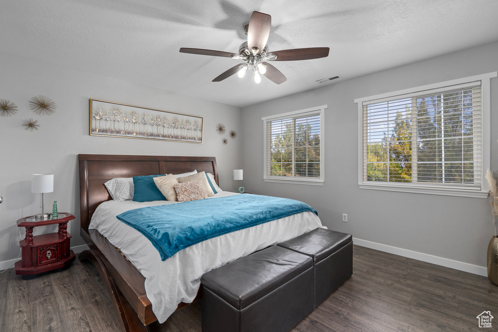 Bedroom featuring dark wood-type flooring and ceiling fan