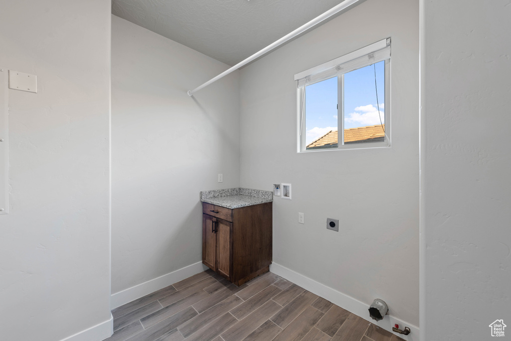 Laundry room with light hardwood / wood-style flooring, hookup for a washing machine, and electric dryer hookup