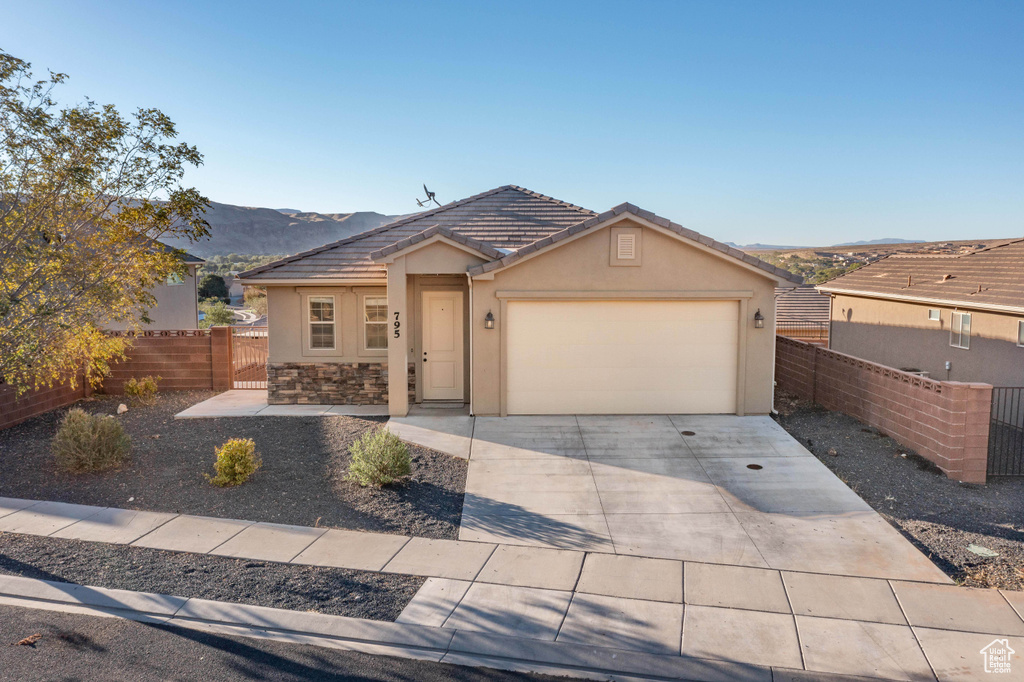 Ranch-style house featuring a garage and a mountain view