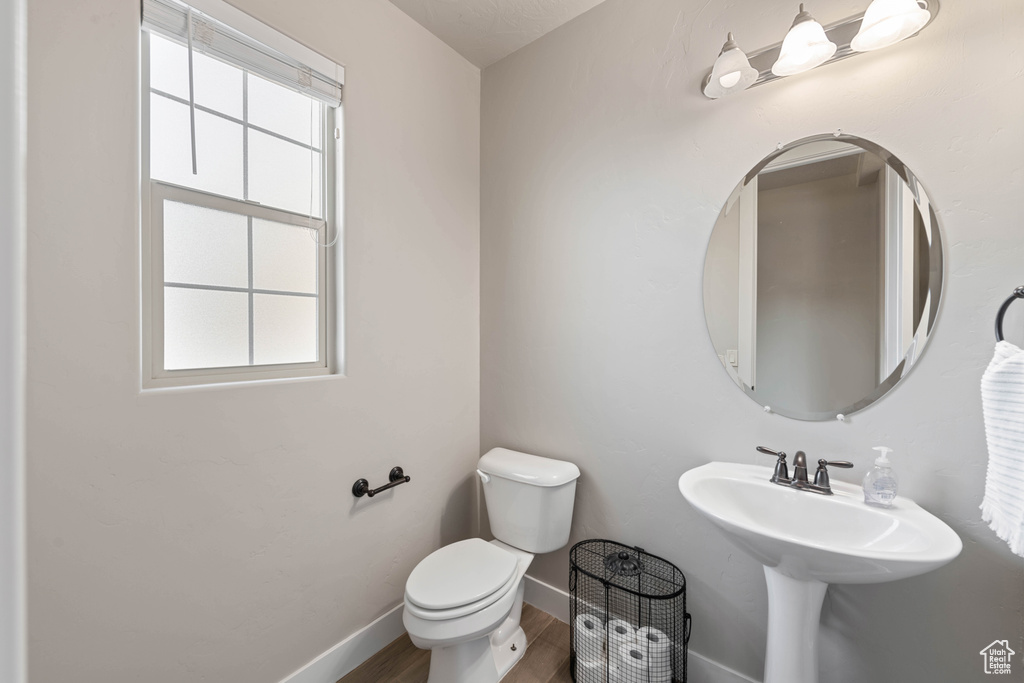 Bathroom featuring wood-type flooring and toilet