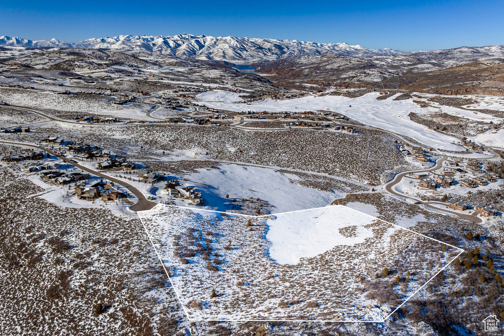 Snowy aerial view featuring a mountain view