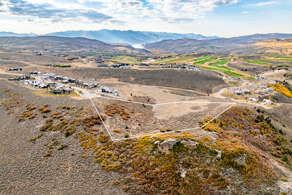 Aerial view of property's location featuring mountains and property parcel outlined