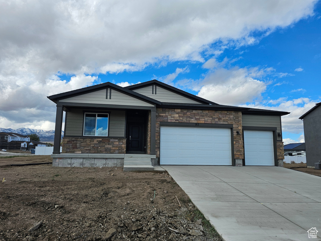 View of front of home featuring a garage and a mountain view