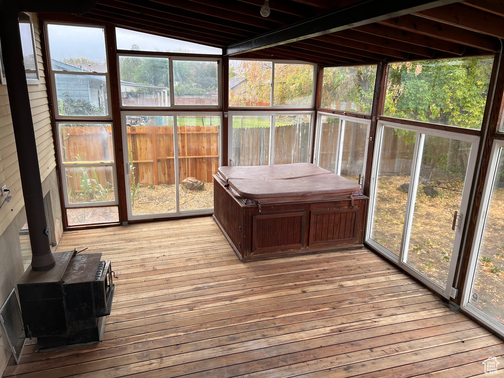 Sunroom with a hot tub, plenty of natural light, and vaulted ceiling