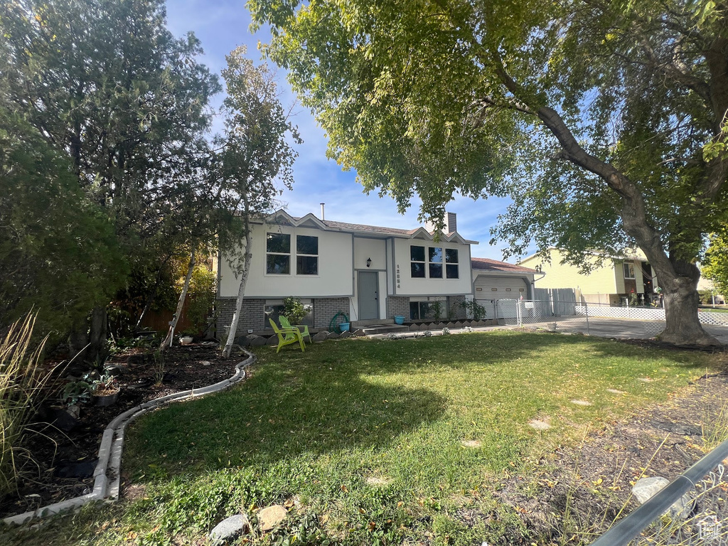 Bi-level home with a front lawn