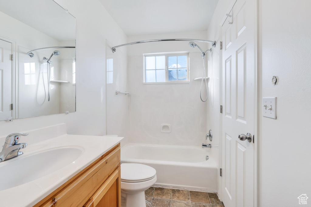 Full bathroom featuring vanity, shower / washtub combination, and toilet