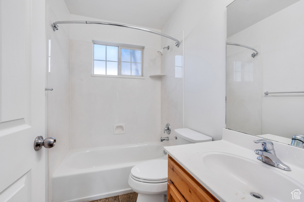 Full bathroom featuring vanity, toilet, and shower / tub combination