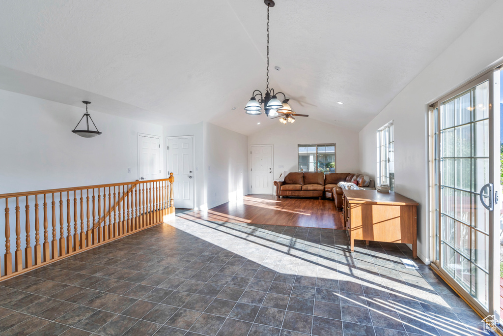 Sitting room with lofted ceiling, an inviting chandelier, and dark hardwood / wood-style flooring