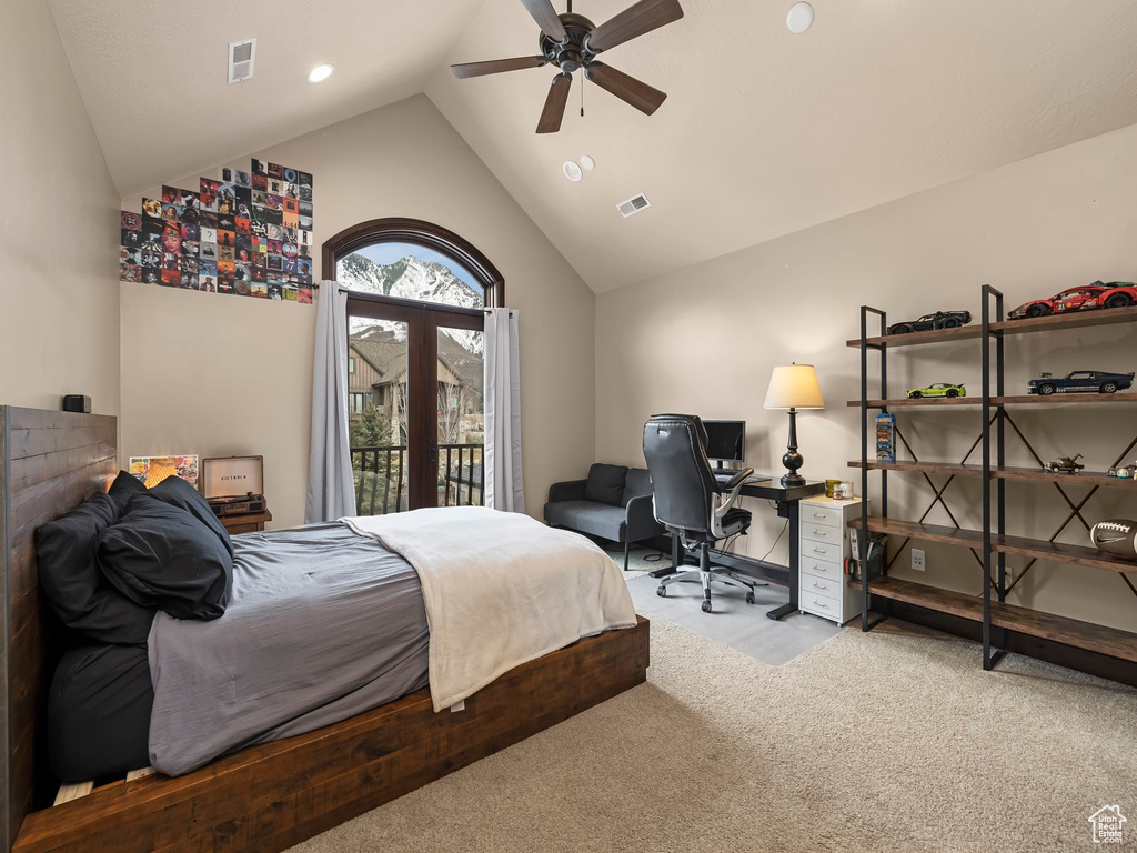 Carpeted bedroom featuring access to outside, high vaulted ceiling, and ceiling fan