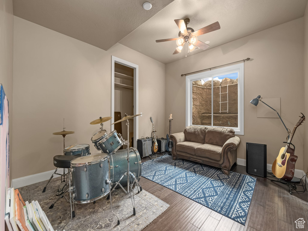 Living room featuring ceiling fan and dark hardwood / wood-style floors