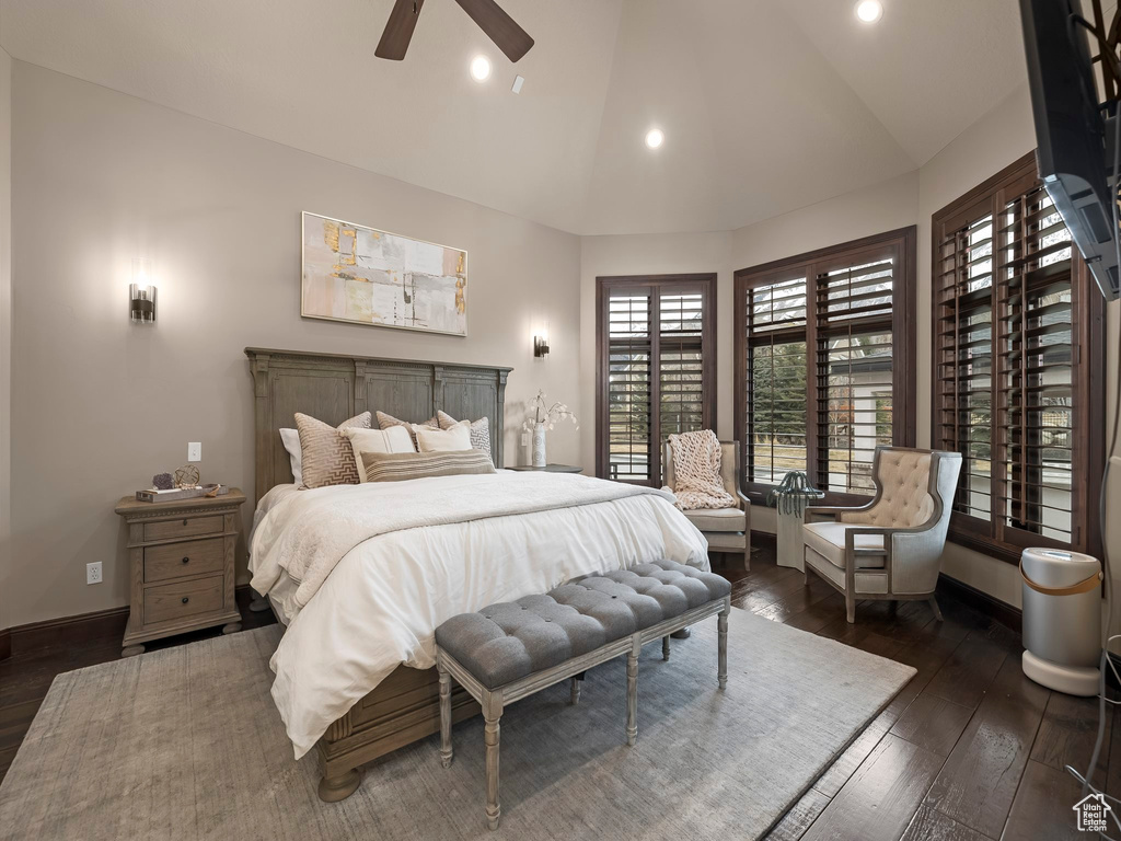 Bedroom with ceiling fan, vaulted ceiling, and dark hardwood / wood-style floors