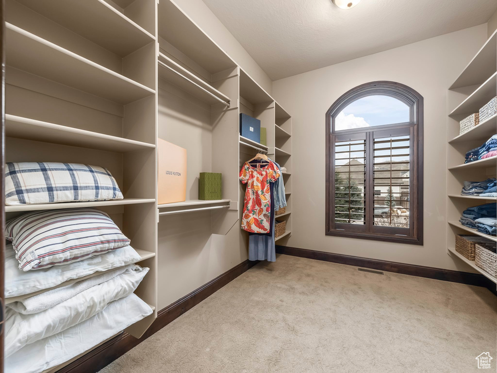 Spacious closet with carpet floors