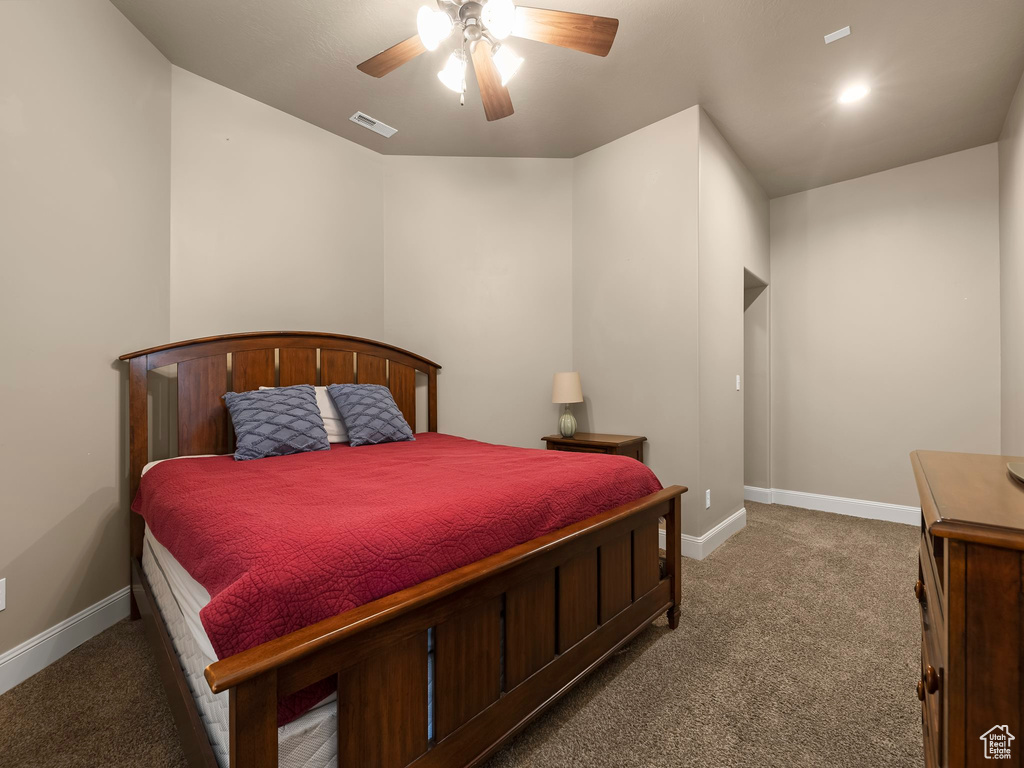 Bedroom featuring dark carpet and ceiling fan