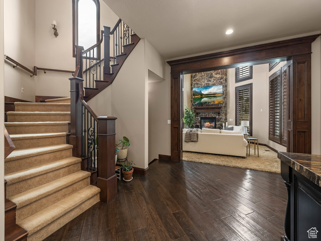 Interior space with a stone fireplace and hardwood / wood-style flooring