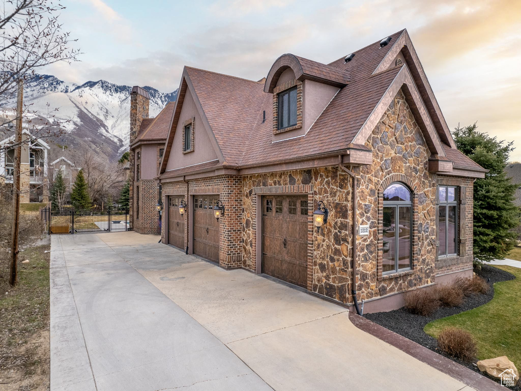 View of front facade featuring a garage and a mountain view