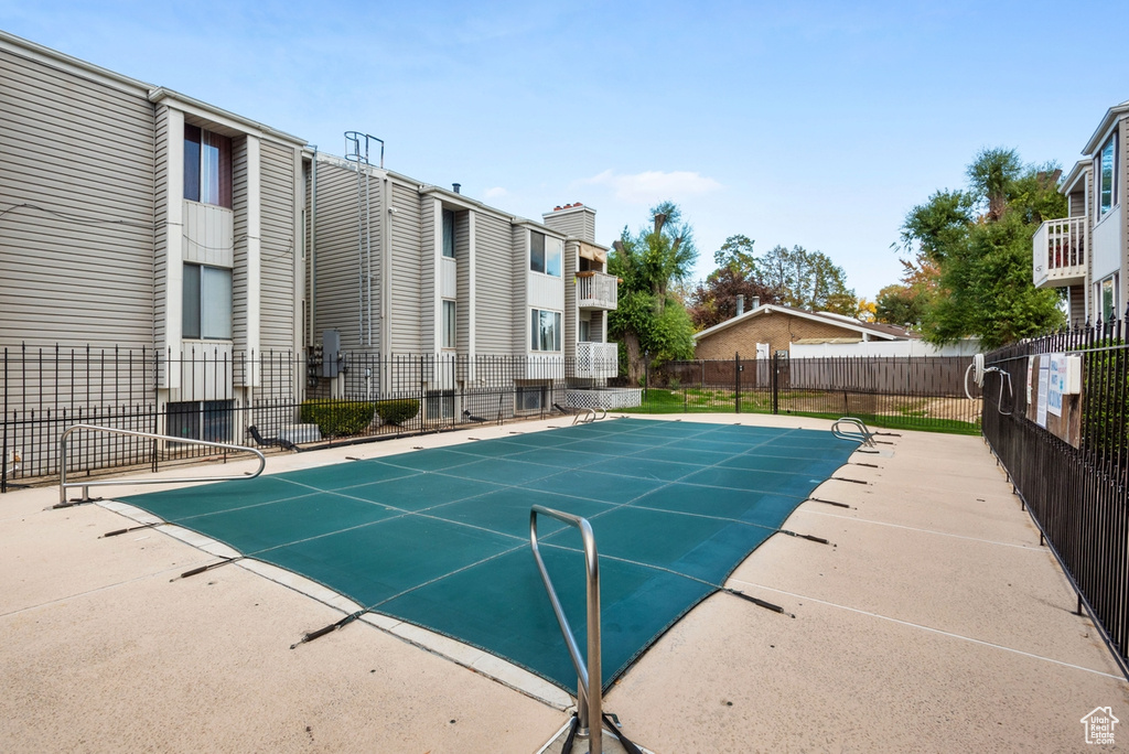 View of pool featuring basketball hoop