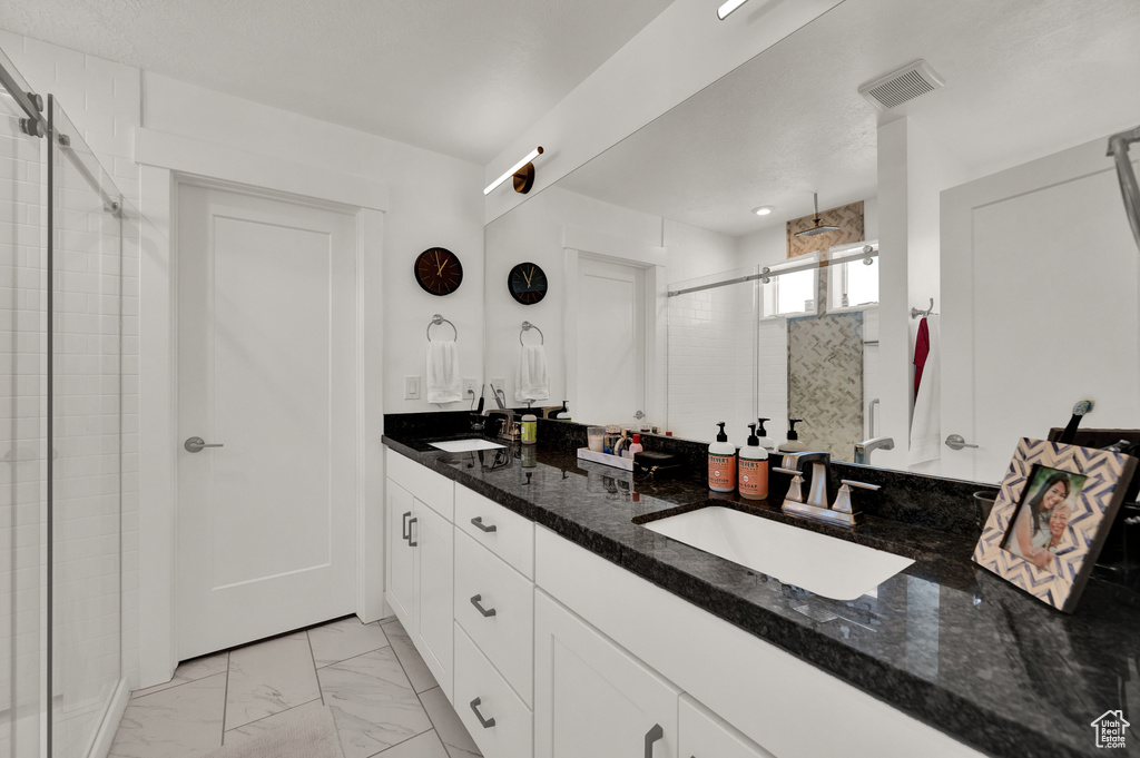 Bathroom with vanity and an enclosed shower