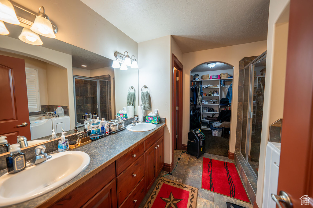 Bathroom featuring vanity, a textured ceiling, and independent shower and bath