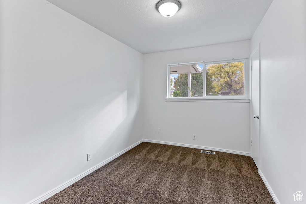 Empty room with carpet flooring