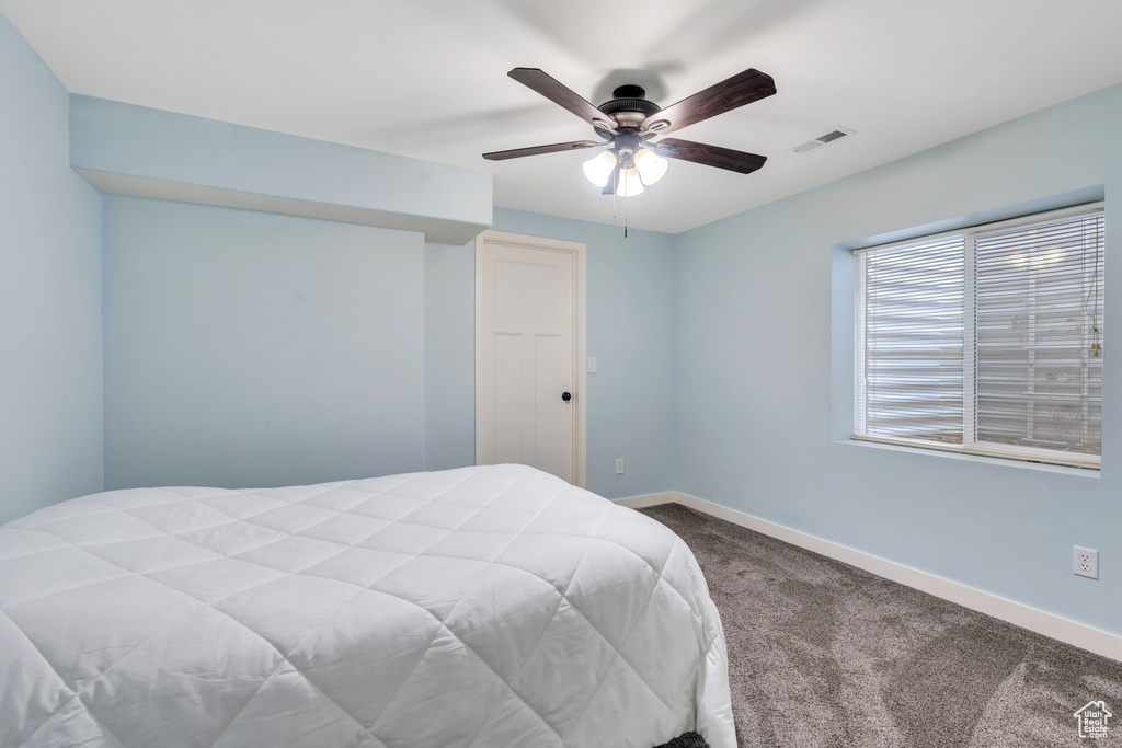 Bedroom with carpet floors, a ceiling fan, baseboards, and visible vents