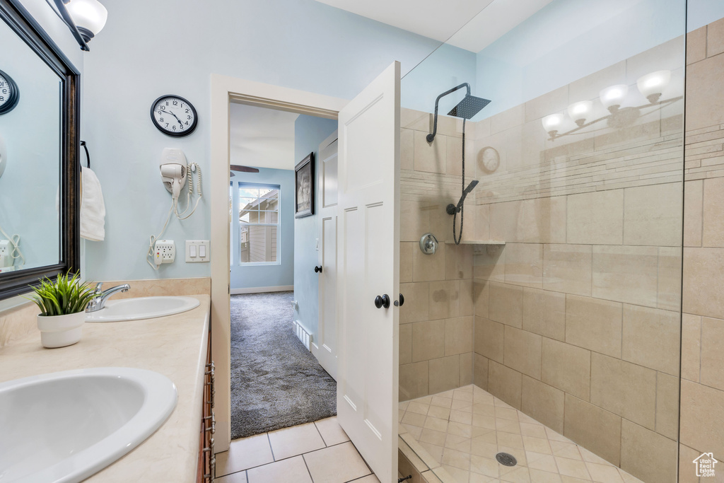 Full bathroom featuring a sink, a walk in shower, tile patterned flooring, and double vanity