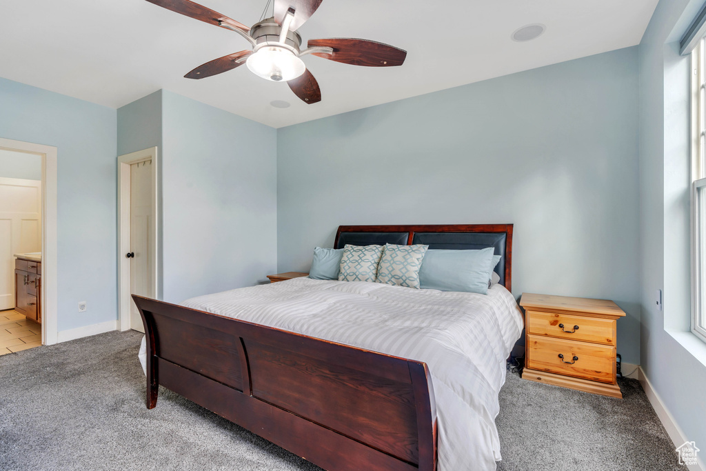 Bedroom with baseboards, ceiling fan, and light carpet