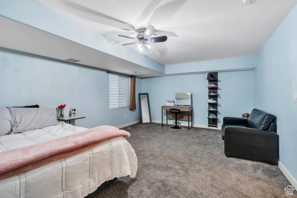 Carpeted bedroom with visible vents, baseboards, and ceiling fan