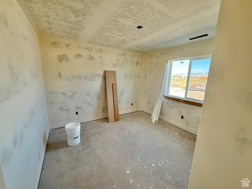 Spare room featuring concrete floors