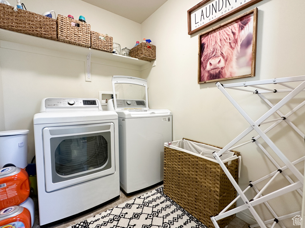 Laundry room with washer and clothes dryer