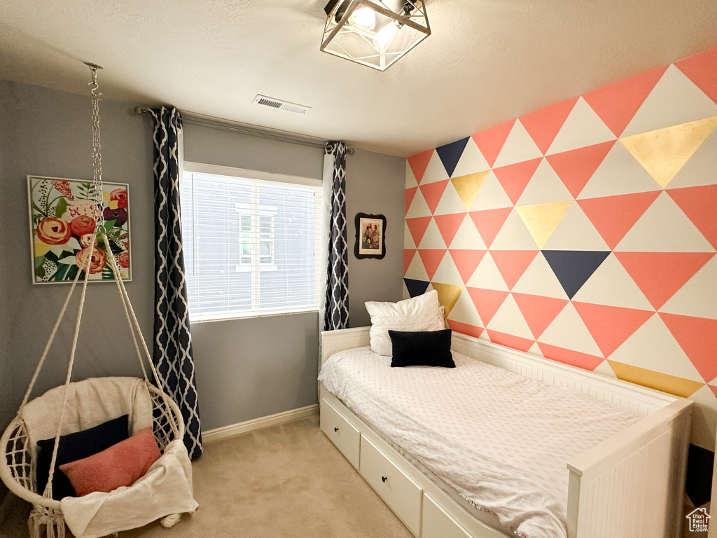 Bedroom with light colored carpet