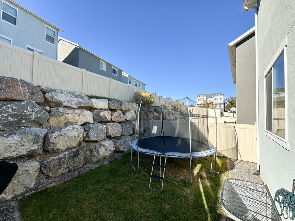 View of yard featuring a trampoline