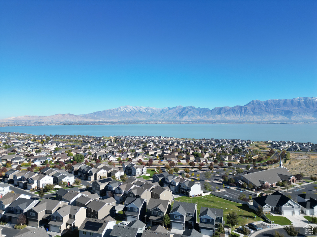 Birds eye view of property featuring a water and mountain view