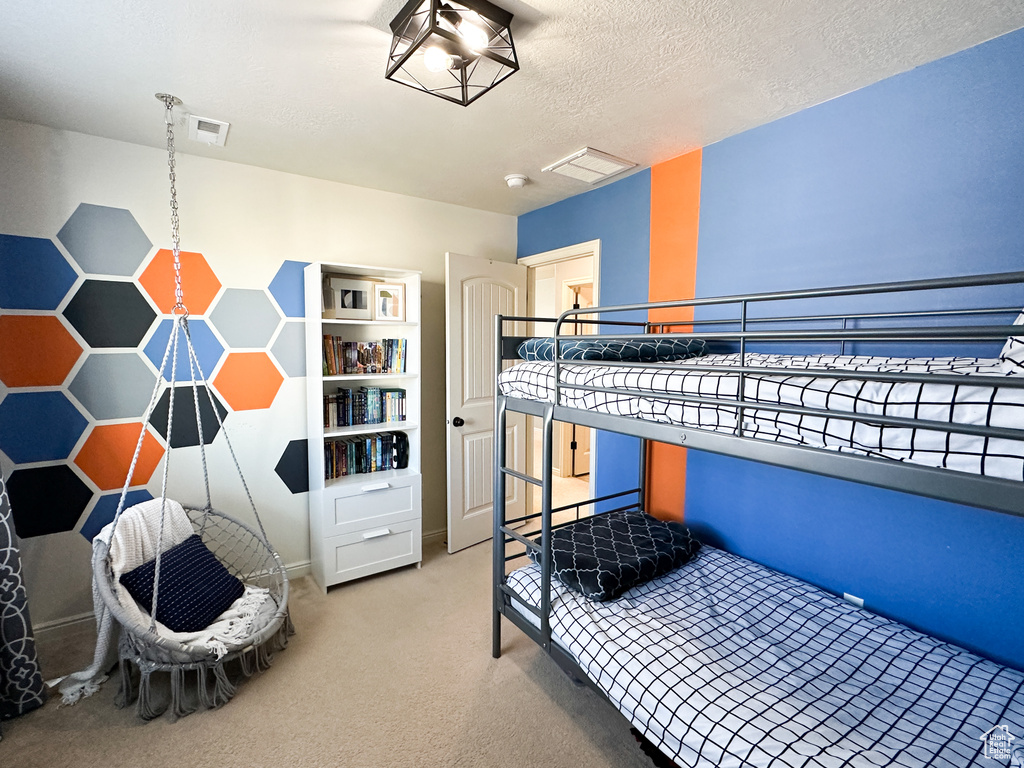 Carpeted bedroom with a textured ceiling