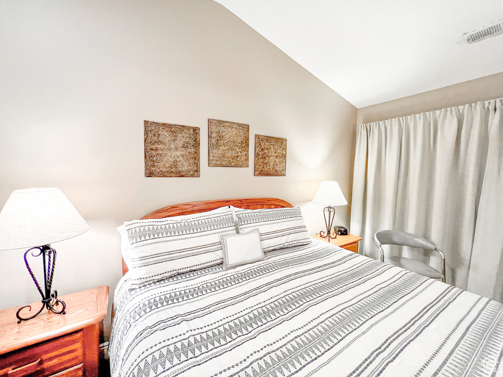 Bedroom featuring vaulted ceiling