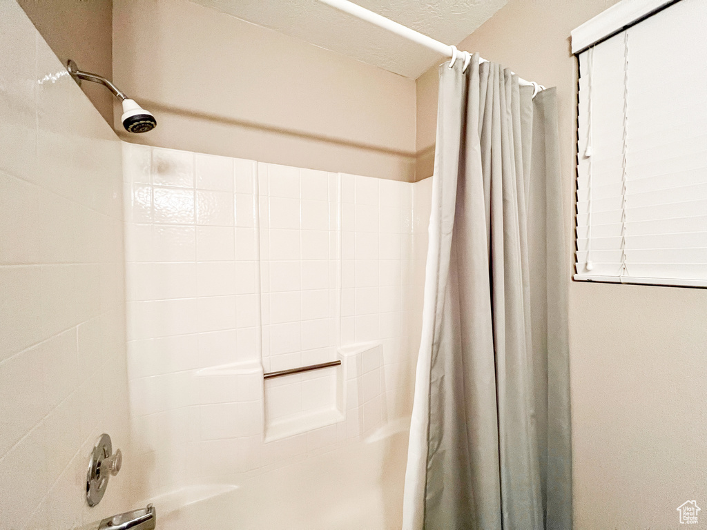 Bathroom featuring curtained shower