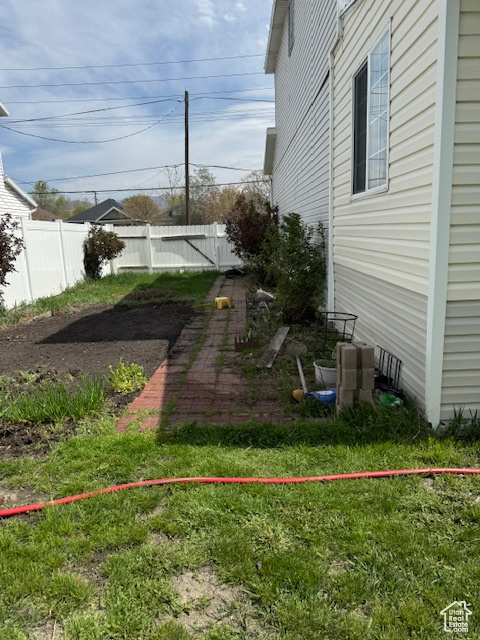 View of yard featuring fence