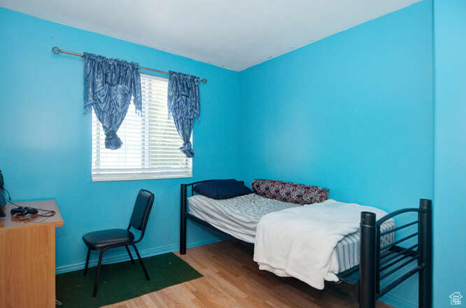 Bedroom featuring wood-type flooring