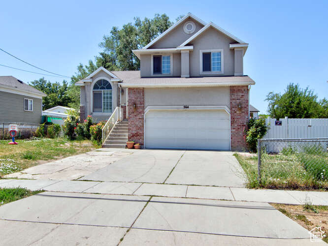 View of front facade featuring a garage