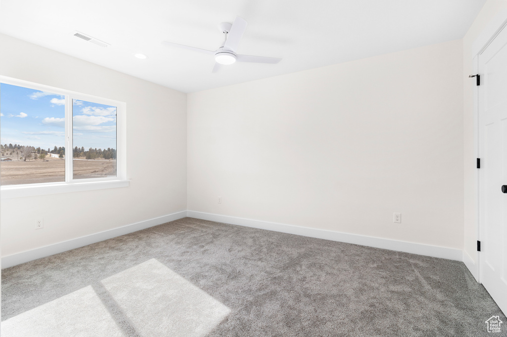 Unfurnished bedroom with a ceiling fan, baseboards, visible vents, and carpet flooring