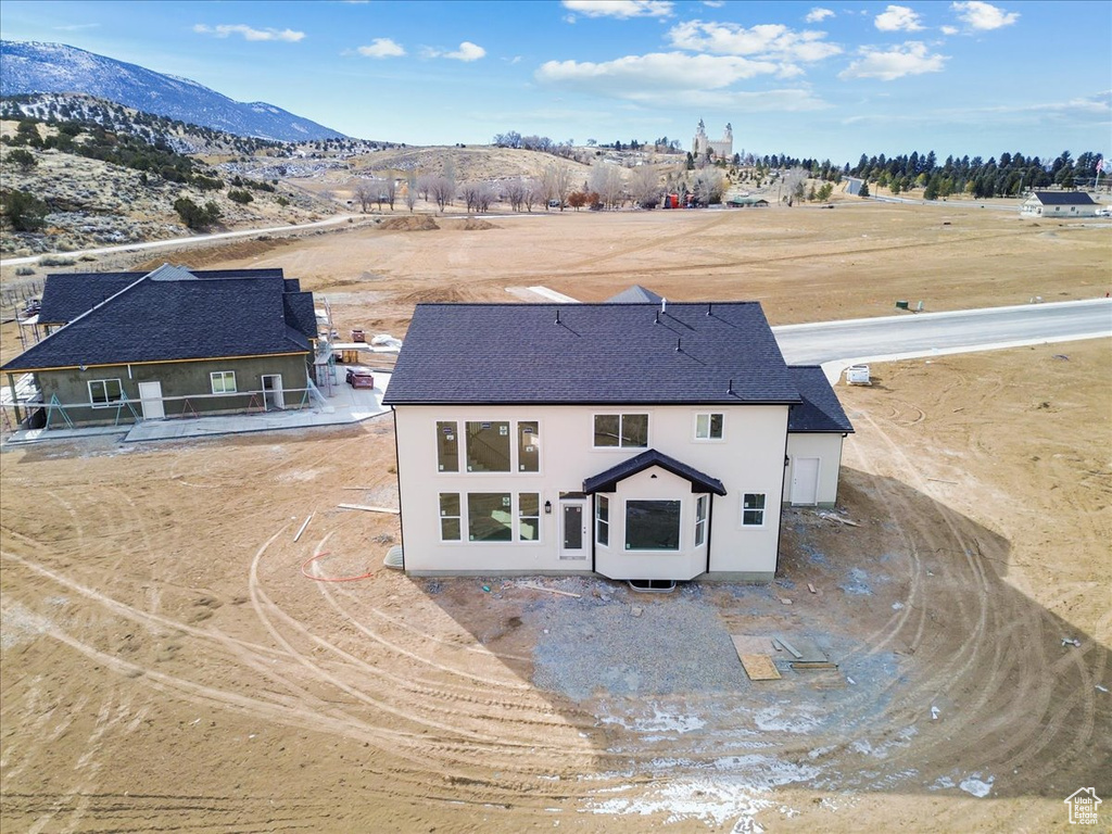 Rear view of house featuring a mountain view