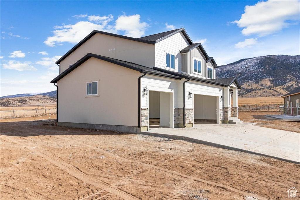 View of home\'s exterior with a mountain view and a garage