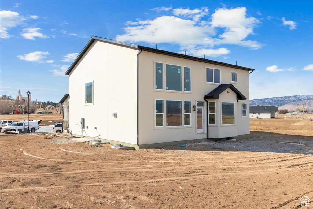 Rear view of property featuring a mountain view