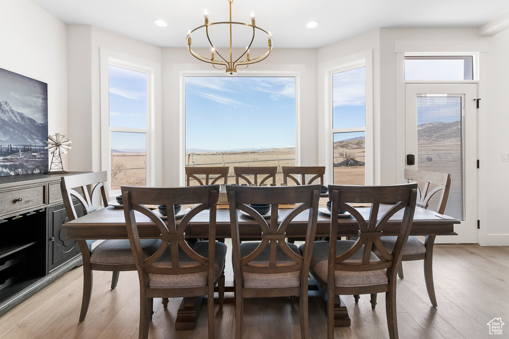 Dining area featuring light wood-type flooring, a chandelier, and recessed lighting