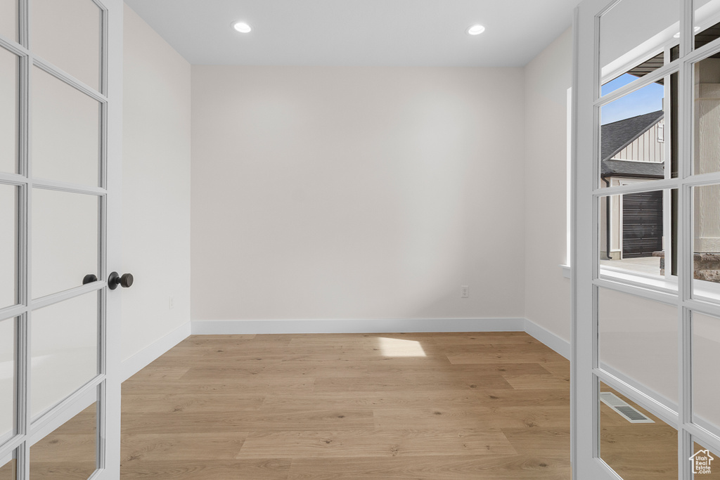 Spare room with recessed lighting, baseboards, visible vents, and light wood finished floors