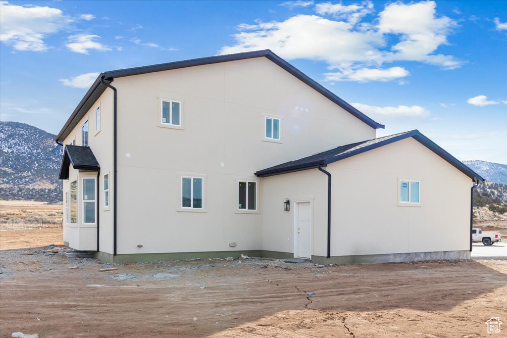 Rear view of property with a mountain view