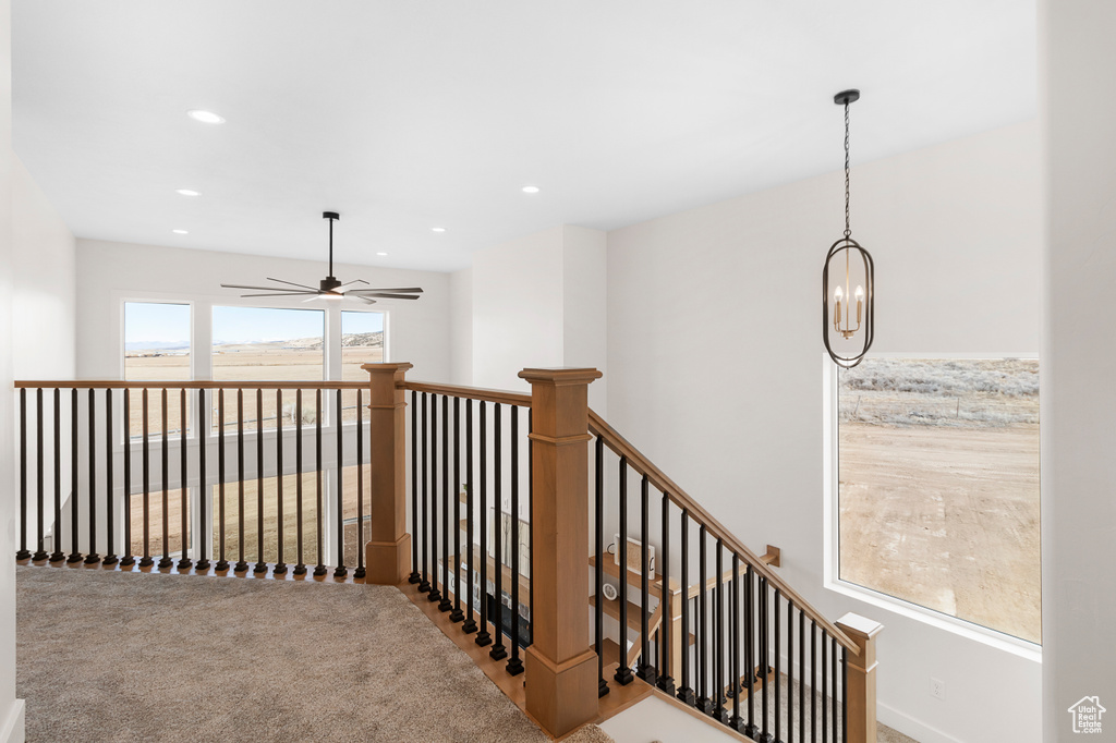 Corridor featuring a notable chandelier, carpet flooring, an upstairs landing, and recessed lighting