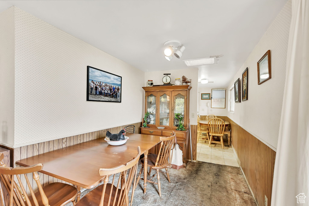 Dining room featuring wooden walls