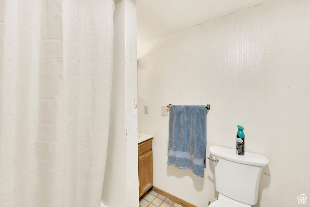 Bathroom featuring vanity, toilet, and walk in shower