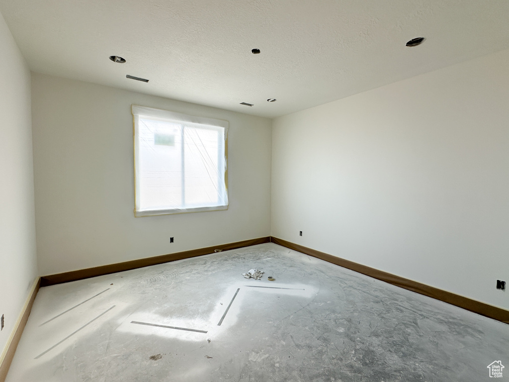 Empty room with a textured ceiling