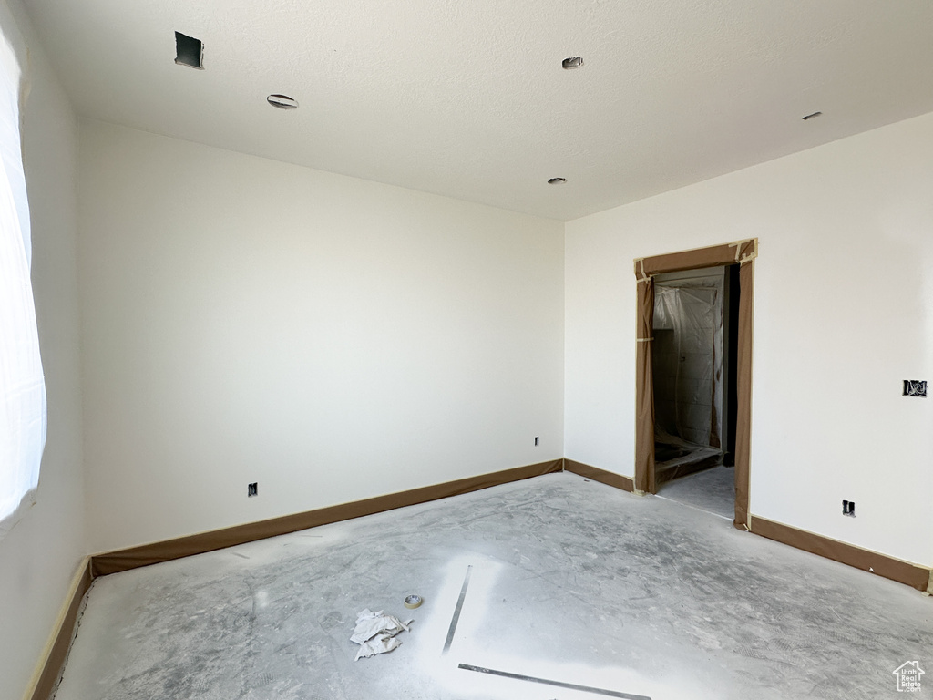 Unfurnished room featuring a textured ceiling